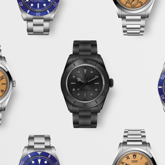 Tudor Armbanduhren Kollektion mit verschiedenen Modellen – darunter Taucheruhren und klassische Designs in Edelstahl, Schwarz und Blau, hochwertig inszeniert auf hellem Hintergrund