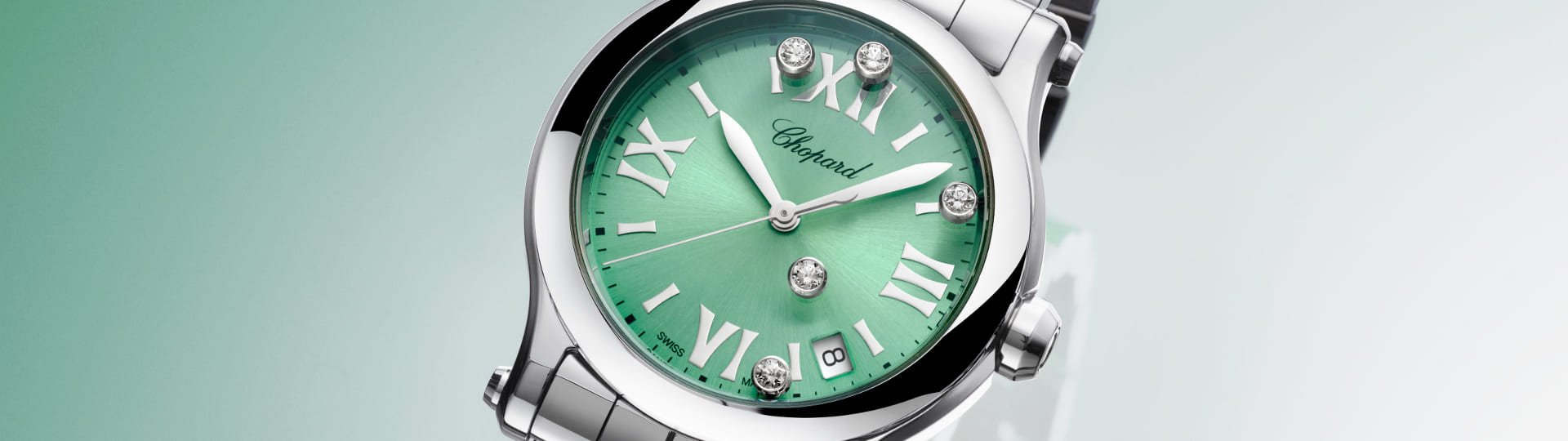 Chopard Happy Sport Damenuhr mit Gehaeuse und Armband in Stahl, mintgruenem Zifferblatt mit roemischen Ziffern und 5 tanzenden Diamanten vor gruenem Hintergrund