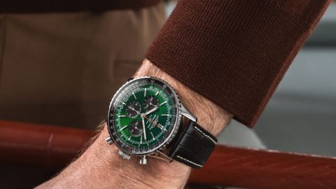 Breitling Navitimer Chronograph in Stahl mit gruenem Zifferblatt und schwarzem Lederarmband an einem Herrenhandgelenk